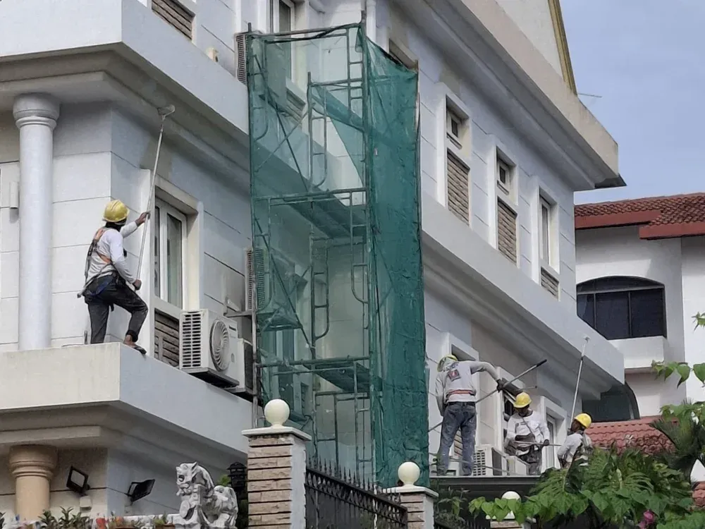 Goal Green World crew working on a building exterior in Singapore
